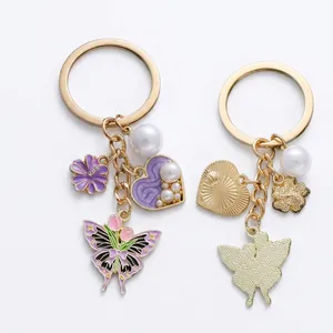 Enamel butterfly and tulip keychain with purple heart charms and white pearls