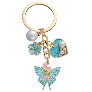 Detail of blue heart pearl keychain with tulip butterfly and rose gold charms