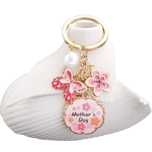 Porte-clés Fête des Mères doré avec papillon en émail rose, fleur et perle