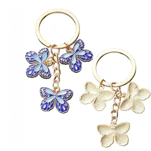 Front and back details of blue enamel butterfly keychain with golden metal finish