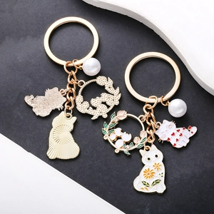 Cartoon cat keychain with enamel flowers and pearls on a premium golden metal ring