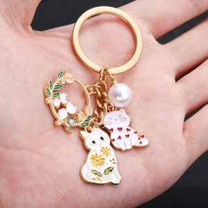 Gold cat keychain with white enamel flower kittens and pearl heart pendants charms