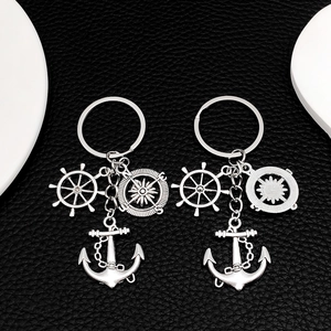 Silver nautical keychain set with anchor, rudder, and compass charms on leather