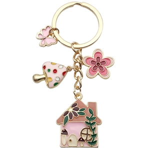 Pink butterfly and mushroom house enamel keychain with flower charms in gold finish