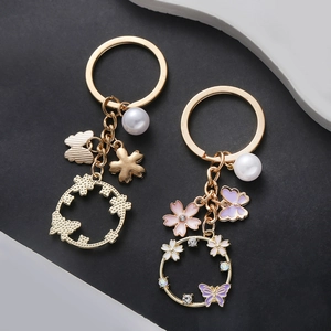 Porte-clés papillon et fleur rose violet avec perles et couronne dorée pour sacs