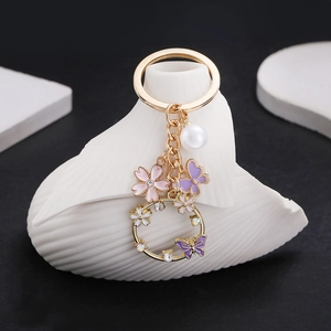 Porte-Clés en Alliage Émaillé Papillon Et Fleur Avec Künstliche Perle d'Imitation Strass Creux Floral Pendentif de Sac Femme Cadeau