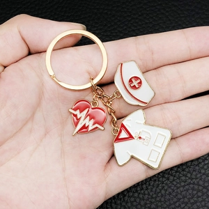 Nurse medical keychain with enamel red heart, nurse hat and white coat on gold alloy