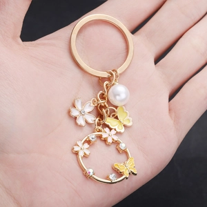 Golden cherry blossom butterfly keychain with white pearl and colorful rhinestones