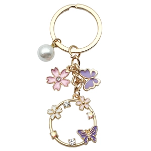 Porte-clés couronne de fleurs papillon rose et violet avec perles et breloques dorées