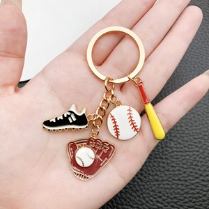 Baseball themed keychain with mini glove bat and shoe charms on a dark textured background
