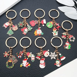 Detail of diverse Christmas keychains with enamel Santa, reindeer, and tree charms