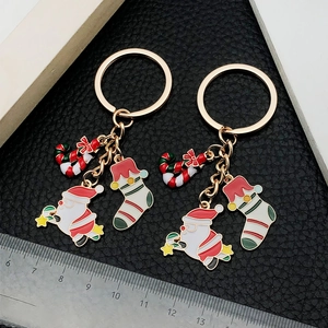 Christmas keychain set with enamel Santa, candy cane and gift sock on gold metal