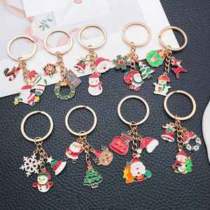 Detailed set of nine Christmas keychains with festive charms on a black textured background