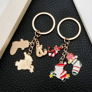 Christmas Santa and stocking metal keychains set with colorful enamel on black background