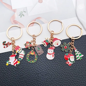Close-up of colorful enamel Christmas keychains with Santa and Merry X-MAS tag