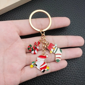 Detailed shot of Christmas keychains with enamel Santa Claus, candy cane, and stocking charms