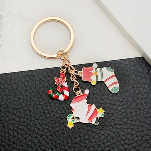 Detail of Christmas keychain with Santa, candy cane, and stocking on leather background