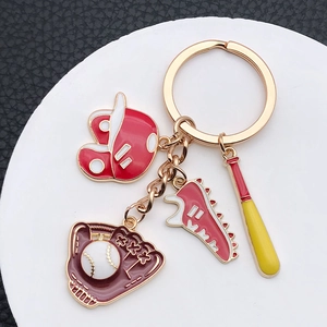 Detailed close-up of a red baseball themed keychain with enamel helmet and glove charms