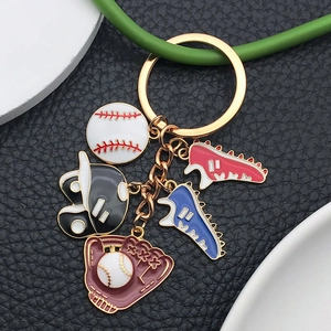 Cartoon baseball keychain with colorful sports charms on premium black leather texture