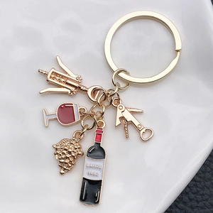 Chic gold wine-themed keychain with mini bottle, opener, glass and grape charms