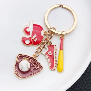 Detail of baseball theme keychain with red enamel helmet, sneaker and glove pendants