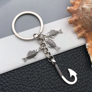 Antique silver fishing hook keychain with three detailed fish pendants on metallic chain