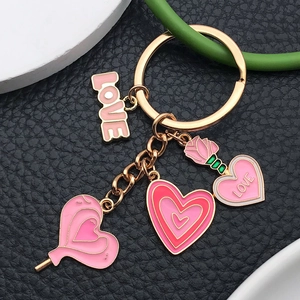 Pink heart and rose enamel keychain with gold LOVE pendants on black leather background