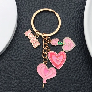Detail of pink enamel heart and rose charms on a rose gold plated keychain