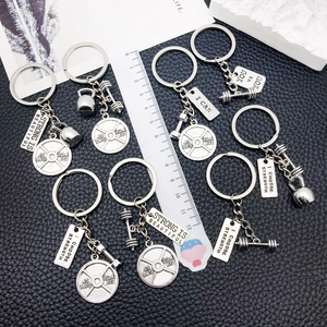 Gym-themed keychain set with dumbbell, kettlebell charms and motivational plaques