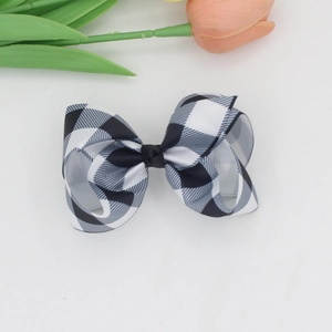 Black and white gingham ribbon bow hair clip with orange tulip on white background