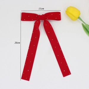 Red velvet bow hair clip with white pearls and long ribbons for elegant hairstyling