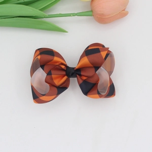 Plaid checkered ribbon bow hair clip with orange and black Scottish pattern