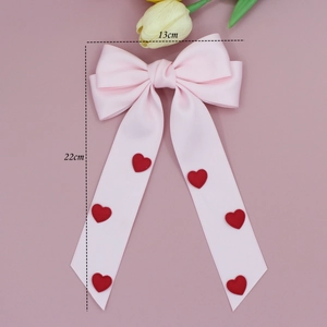 Barrette à cheveux avec nœud en ruban rose et cœurs rouges 3D sur de longs rubans