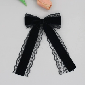 Detailed view of vintage black velvet hair clip with delicate long floral lace ribbons