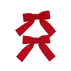 Pair of sweet red velvet hair bows with white bead embellishments on white background