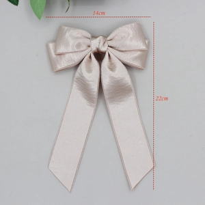 Elegant satin bow hair clip with long streamers in champagne pink, size 14x22cm