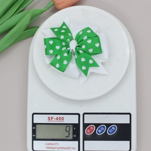 Close-up of lightweight St. Patrick's Day shamrock bow hair clip weighing only 9 grams