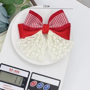 Red and white houndstooth bow hair clip with lace detail and 12cm width dimension