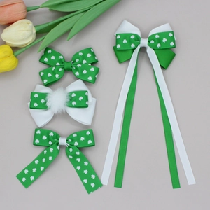 Four St. Patrick's Day green clover hair bows with streamers and white pom-poms