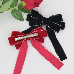 Elegant velvet bow hair clips with long ribbons and contrast stitching in black and red