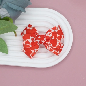 Detailed close-up of a red Valentine grosgrain ribbon bow hair clip with LOVE text