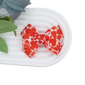 Valentine ribbon hair clip with red hearts and LOVE print on white grosgrain bow