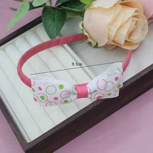 Détail d'un serre-tête rose avec nœud en gros-grain imprimé de 9,5 cm pour petites filles