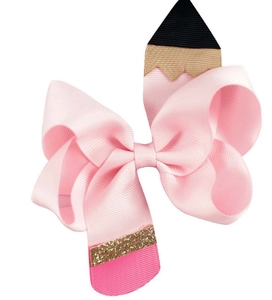 Close-up of pink pencil shaped grosgrain ribbon hair bow with gold glitter details