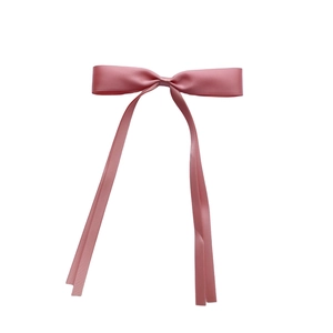 Detail of elegant pink satin bow hair clip with long ribbons and smooth silk texture