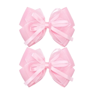 Detailed close-up of pink layered organza and grosgrain ribbon hair bow clips