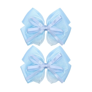 Detail view of two light blue organza and grosgrain layered bow hair clips for girls
