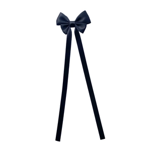 Detail of elegant black satin bow hair clip with long ribbon streamers for women