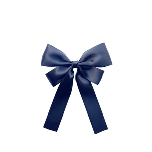 Elegant navy blue satin ribbon bow hair clip with long streamers on white background