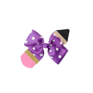 Detail of purple polka dot grosgrain bow hair clip with creative pencil shape design